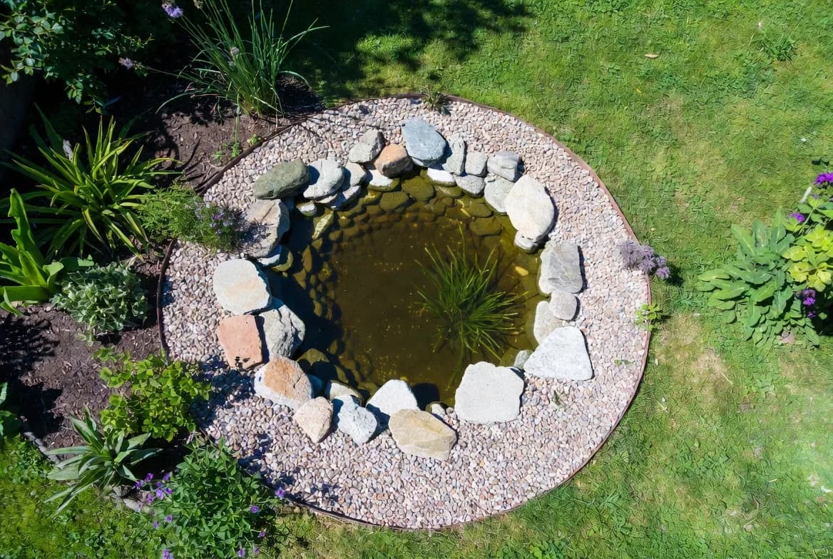 A completed circular wildlife pond viewed from above